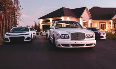 Texas family with personal and business-use cars in driveway