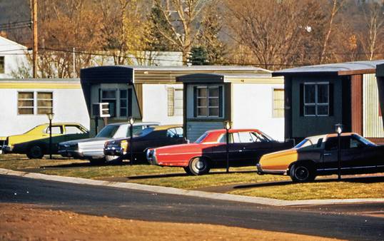 A Texas family and multiple cars parked in a driveway, showing a typical multi-car policy scenario