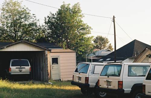 Roommates or young adults with multiple cars parked at a Texas home