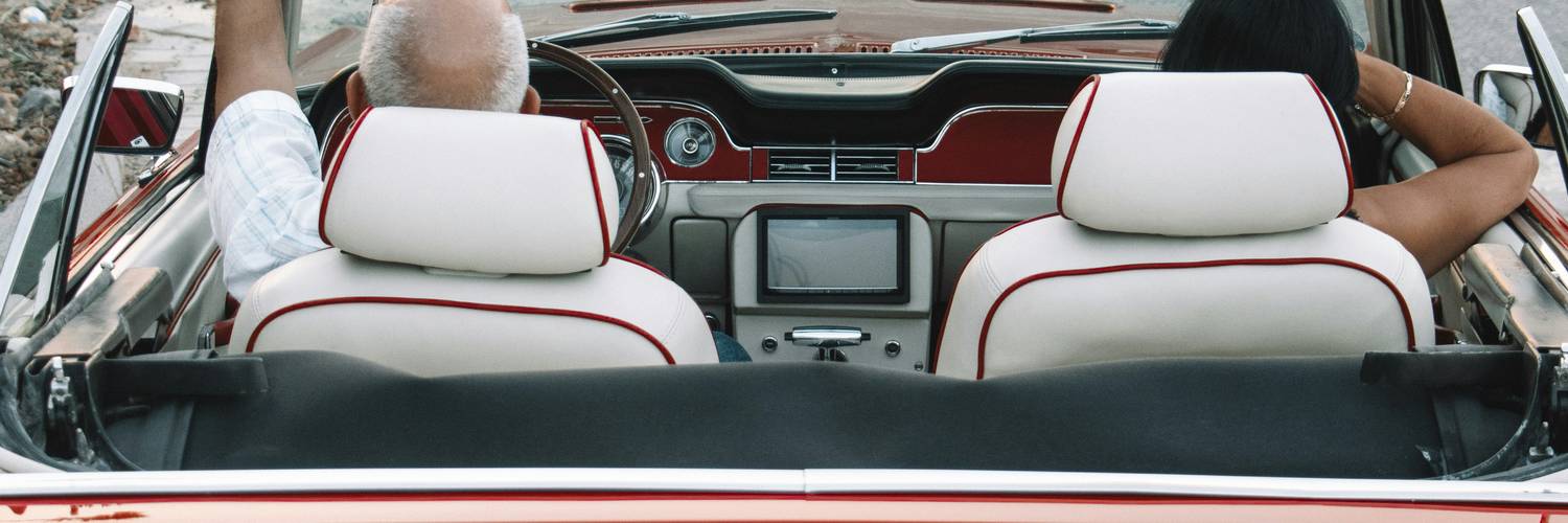 Senior couple or mature adult driving a car on a Texas road or highway, symbolizing confident senior drivers in Texas