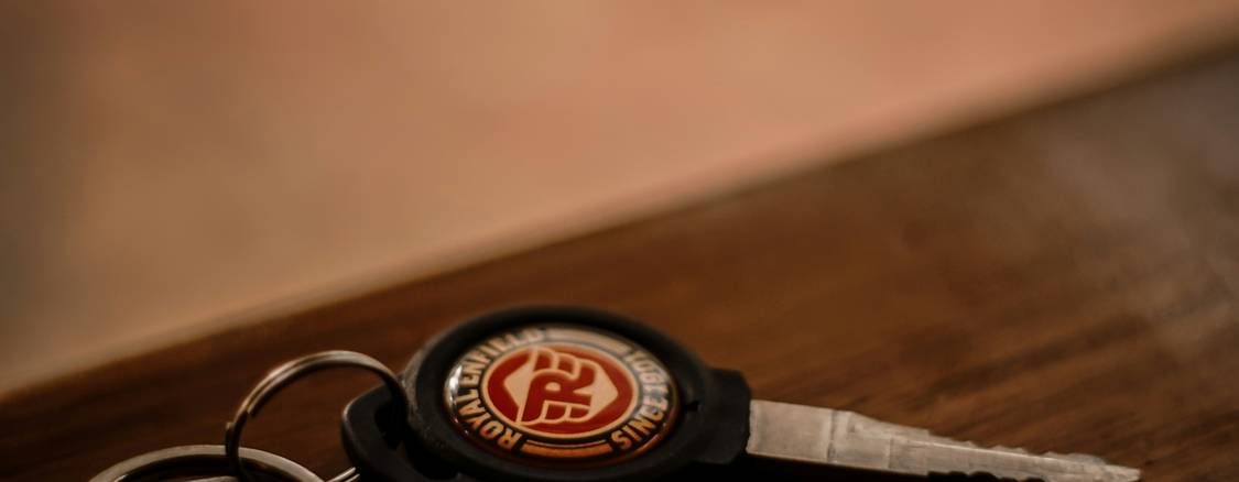 A set of car keys and insurance documents at a rental counter, representing non-owner auto insurance in Texas.