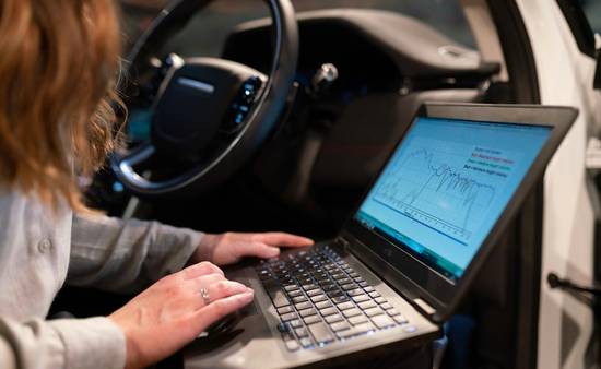 Illustration of a Texas driver using an online auto insurance calculator or digital insurance tool, showing a laptop or mobile device on a desk