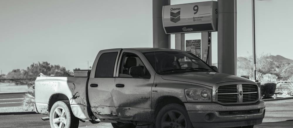 A tow truck providing roadside assistance to a stranded car on a Texas highway