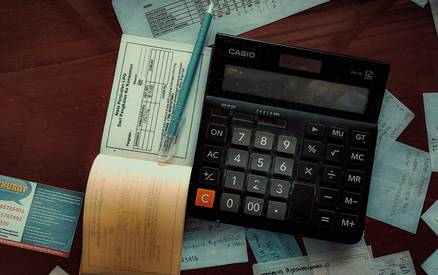 Texas auto insurance paperwork and calculator on a desk